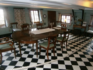 The captains quarters on HMS Unicorn. These were typical of the day, although the fine furniture was traditionally towed behind the vessel in a jolly boat and guns were mounted in this area when the ship was cleared for action.