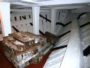 Ships need ballast at their lowest point to keep them upright - especially saiilng vessels. This is the standard navy cast iron ballast used 200 years ago. Note also the solid construction of the hull of HMS Unicorn - all English oak.
