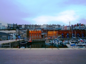 An evening view across the inner harbour towards the south end of Ramsgate. The chalk cliffs can be seen tot he left and the stairs up them which lead to Waitrose's