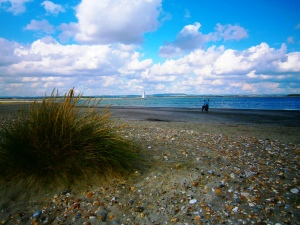The Chichester River by East Head. There is a popular anchorage in front of this beach which the yacht is making for.
