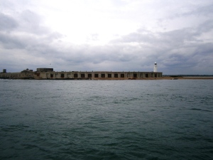 Hurst Castle  is one of Henry VIII's Device Forts, built at the end of a long shingle spit at the west end of the Solent to guard the approaches to Southampton. Hurst Castle was sited at the narrow entrance to the Solent where the ebb and flow of the tides creates strong currents, putting would-be invaders at its mercy. Also known as a Henrician Castle, Hurst was built as part of Henry's chain of coastal defences to protect England during the turbulent times of his reign. Charles I was imprisoned here in 1648 before being taken to London to his trial and execution. The fort was modified throughout the 19th century, and two large wing batteries were built to house heavy guns. It was fortified again in World War II and then decommissioned. It is now owned by English Heritage